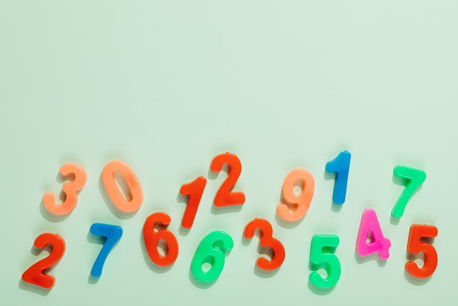 Bright plastic numbers on a mint green background for learning and education.