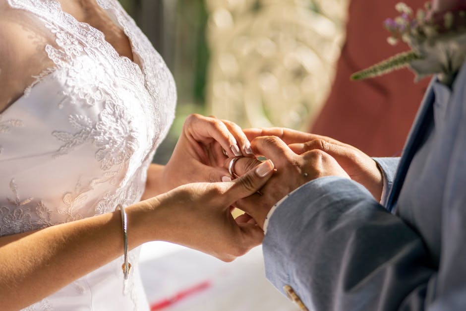 Close-up of a couple exchanging rings, capturing the intimacy and emotion of a wedding ceremony.